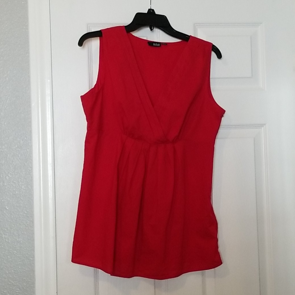 Red sleeveless top with v neck and pleated front